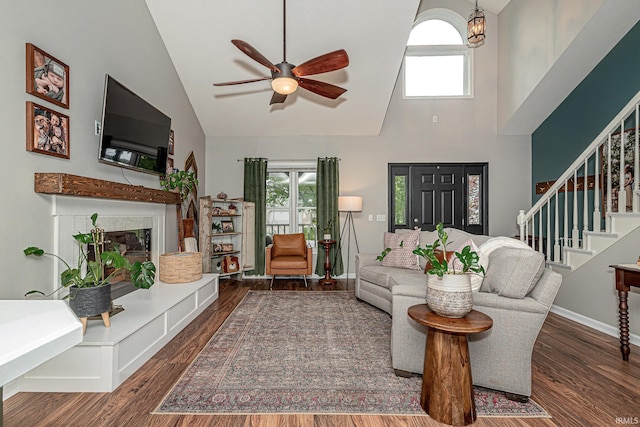 845 N Timberline Cir E, Warsaw, IN 46582 - living area with high vaulted ceiling, ceiling fan, wood finished floors, healthy amount of natural light, and a fireplace with raised hearth