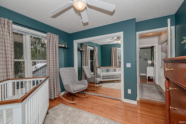 845 N Timberline Cir E, Warsaw, IN 46582 - bedroom featuring wood finished floors, a closet, a ceiling fan, and baseboards