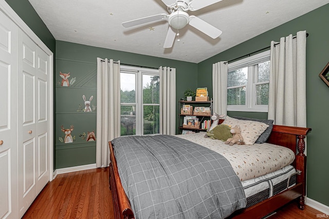 845 N Timberline Cir E, Warsaw, IN 46582 - bedroom featuring multiple windows, wood finished floors, a closet, and baseboards