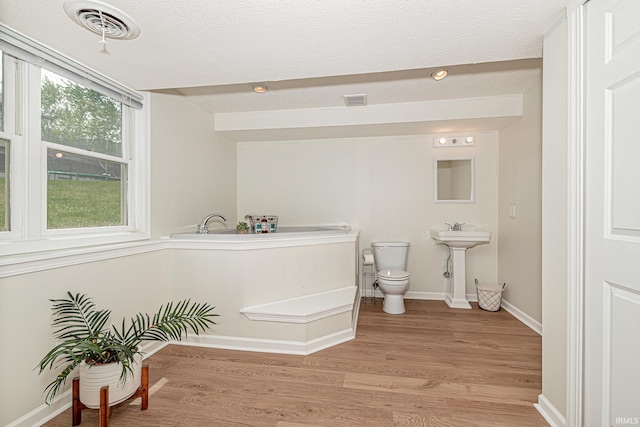 845 N Timberline Cir E, Warsaw, IN 46582 - bathroom featuring toilet, wood finished floors, baseboards, and a textured ceiling