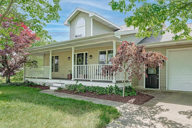 845 N Timberline Cir E, Warsaw, IN 46582 - view of front of house with a porch, concrete driveway, roof with shingles, a front yard, and an attached garage