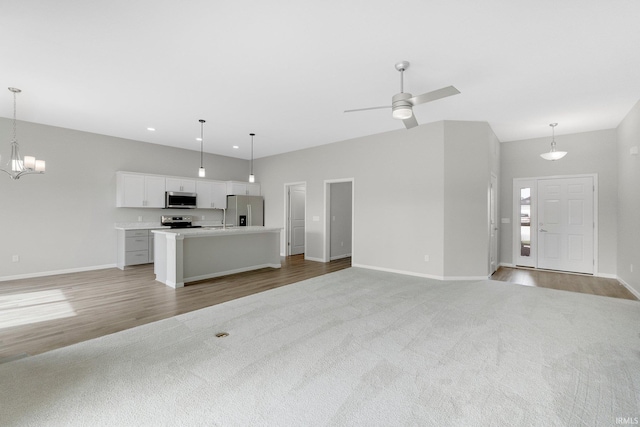 7696 Lila Way, Fort Wayne, IN 46835 - unfurnished living room with baseboards, light colored carpet, light wood-style floors, and recessed lighting