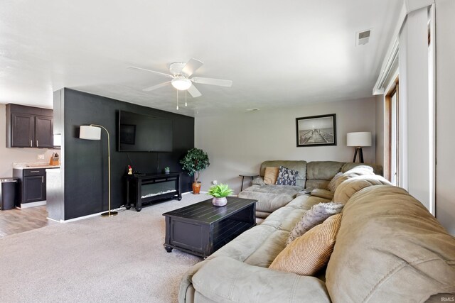 7205 Eby Rd, Fort Wayne, IN 46835 - living area featuring a ceiling fan, light carpet, and baseboards
