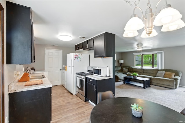 7205 Eby Rd, Fort Wayne, IN 46835 - kitchen with white appliances, a sink, light countertops, light wood-style flooring, and ceiling fan