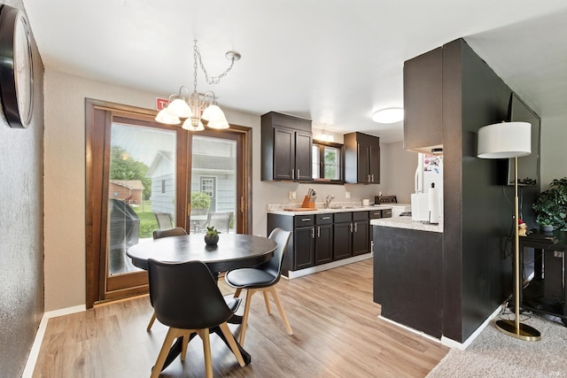 7205 Eby Rd, Fort Wayne, IN 46835 - dining room featuring a chandelier, light wood finished floors, baseboards, and a textured wall