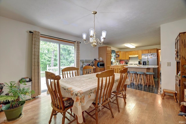 7373 Locust Lake Rd, Spencer, IN 47460 - dining room with a chandelier and light wood-type flooring