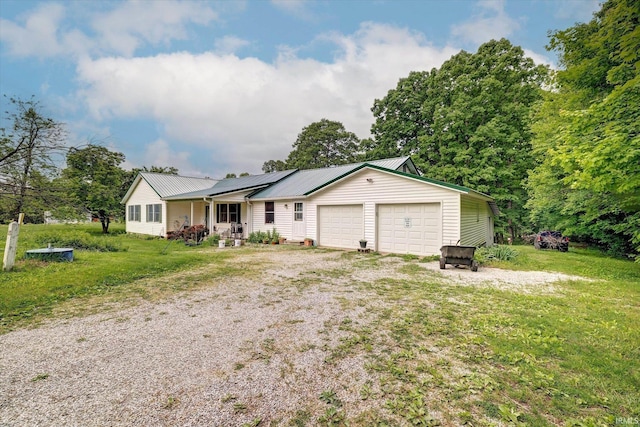 7373 Locust Lake Rd, Spencer, IN 47460 - ranch-style home with a porch, a garage, a front yard, metal roof, and solar panels