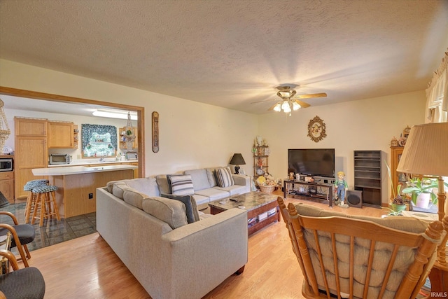 7373 Locust Lake Rd, Spencer, IN 47460 - living area featuring ceiling fan, light wood finished floors, and a textured ceiling