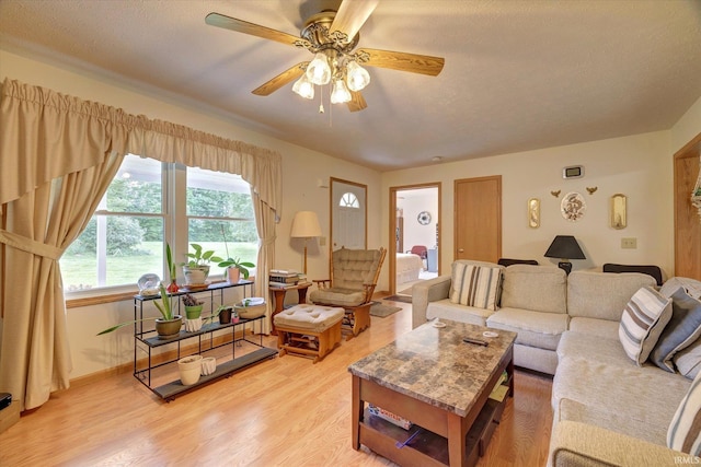 7373 Locust Lake Rd, Spencer, IN 47460 - living area with a ceiling fan, light wood-style flooring, and baseboards