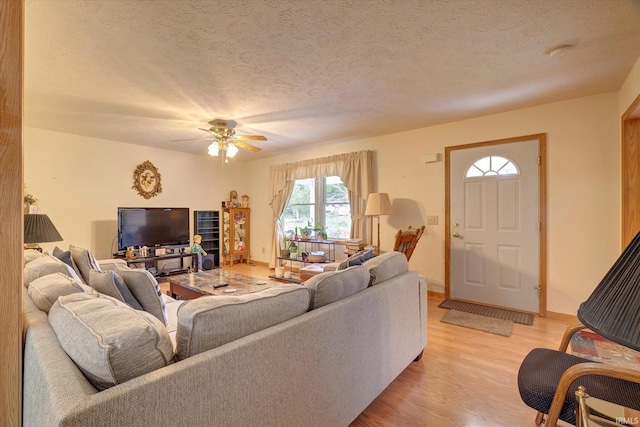 7373 Locust Lake Rd, Spencer, IN 47460 - living room with light wood-style flooring, ceiling fan, and a textured ceiling