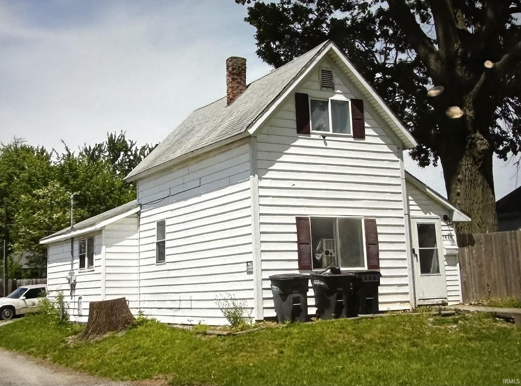 view of side of property with a chimney