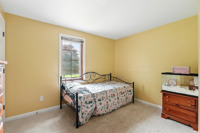 carpeted bedroom featuring baseboards