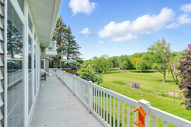 wooden deck with a lawn and view of scattered trees