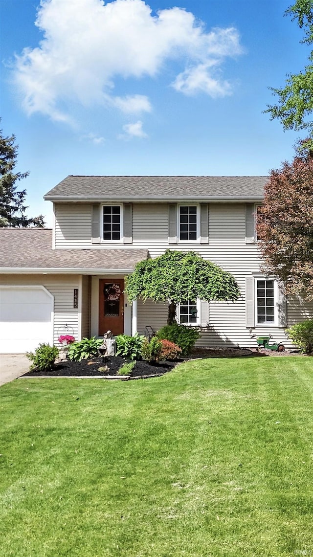 view of front of property with a front yard, a garage, and concrete driveway