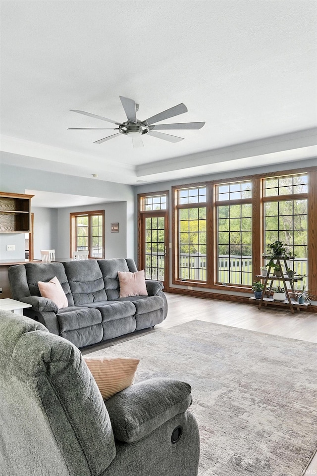 living area featuring wood finished floors and a ceiling fan