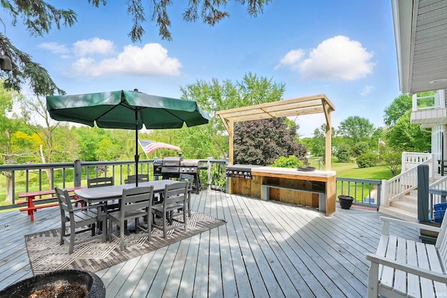 deck with outdoor dining area and view of scattered trees