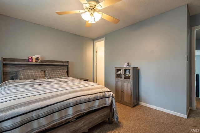 3879 Woodmere Way, Bloomington, IN 47403 - bedroom with light colored carpet, baseboards, and a ceiling fan