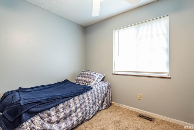 3879 Woodmere Way, Bloomington, IN 47403 - carpeted bedroom with baseboards and a ceiling fan