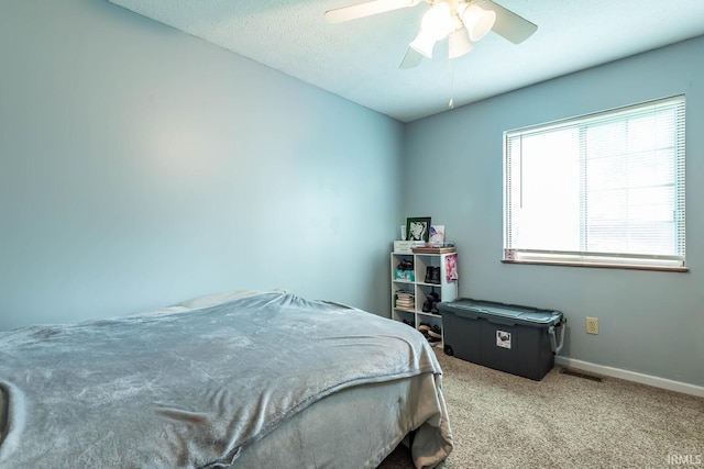 3879 Woodmere Way, Bloomington, IN 47403 - carpeted bedroom with baseboards and a ceiling fan