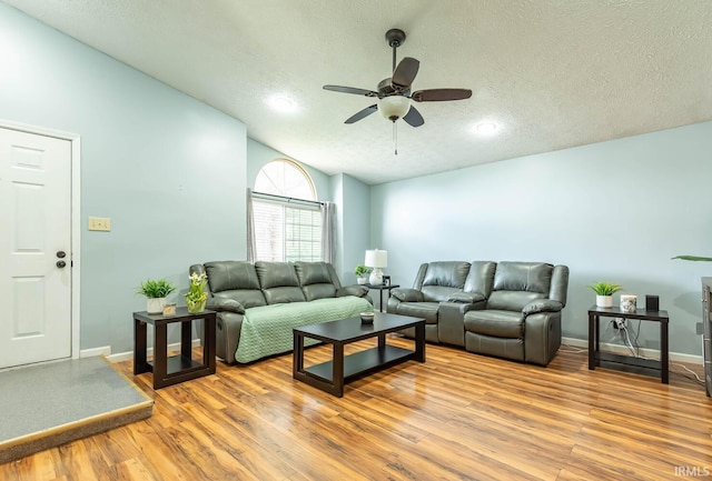 3879 Woodmere Way, Bloomington, IN 47403 - living room with a ceiling fan, a textured ceiling, wood finished floors, vaulted ceiling, and baseboards