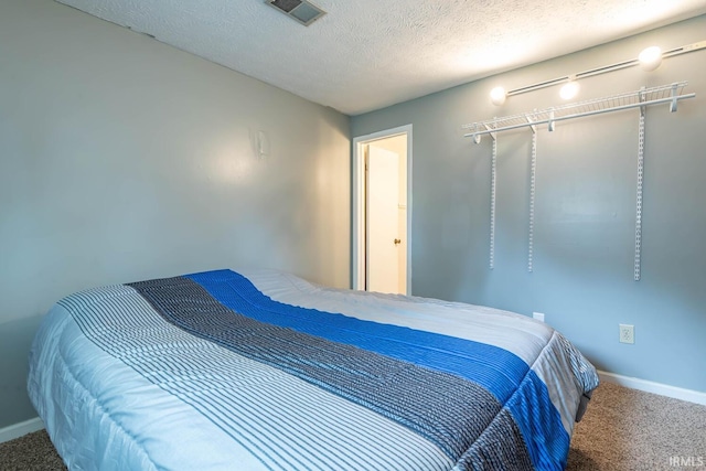 3879 Woodmere Way, Bloomington, IN 47403 - carpeted bedroom with baseboards and a textured ceiling