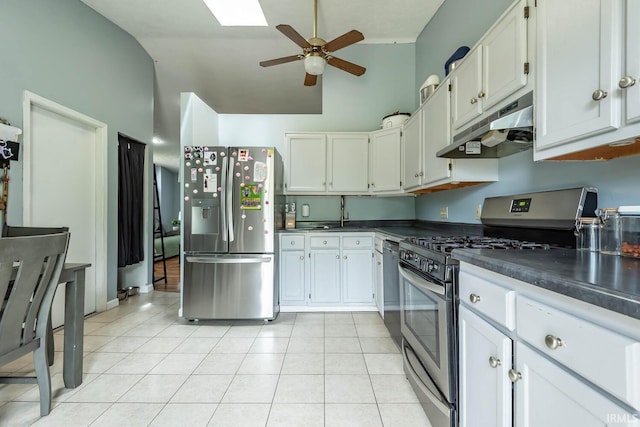 3879 Woodmere Way, Bloomington, IN 47403 - kitchen with appliances with stainless steel finishes, under cabinet range hood, dark countertops, a ceiling fan, and light tile patterned floors