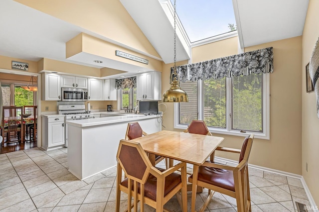 3455 Bridgetown Rd, Bristol, IN 46507 - dining area featuring plenty of natural light, a skylight, baseboards, light tile patterned flooring, and vaulted ceiling
