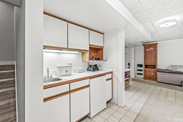 3455 Bridgetown Rd, Bristol, IN 46507 - kitchen with a sink, light tile patterned floors, light countertops, white cabinetry, and white dishwasher