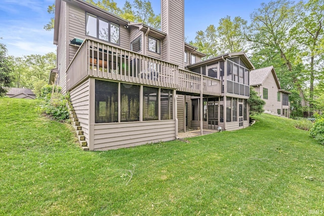 3455 Bridgetown Rd, Bristol, IN 46507 - rear view of house with a sunroom, a chimney, a lawn, and a wooden deck