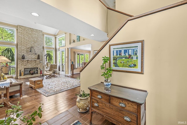 3455 Bridgetown Rd, Bristol, IN 46507 - living room featuring high vaulted ceiling, a fireplace, wood finished floors, recessed lighting, and stairs