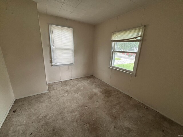 6714 Bradbury Ave, Fort Wayne, IN 46809 - spare room featuring carpet flooring and baseboards