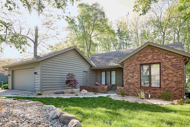 ranch-style home featuring brick siding, roof with shingles, a garage, and a front lawn