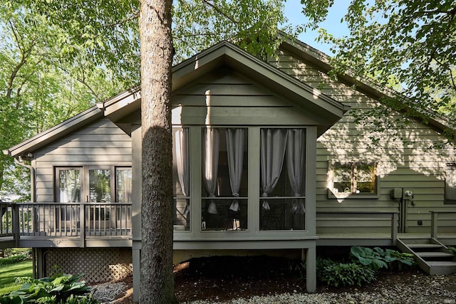 rear view of house with a wooden deck