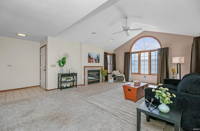 1600 Blue Heron Way S, Bend, IN 46628 - living area featuring light colored carpet, a ceiling fan, vaulted ceiling, a fireplace, and baseboards