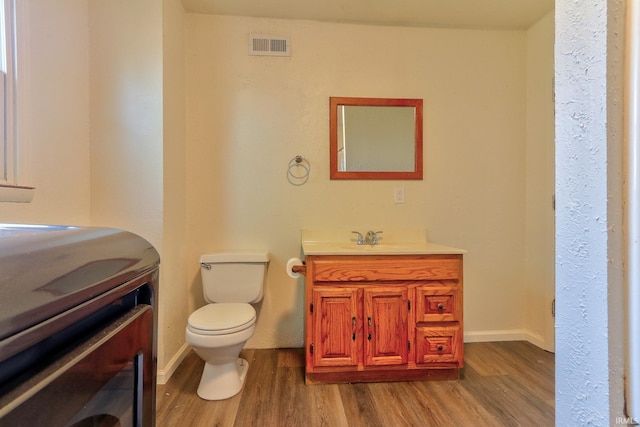 120 W Williams St, Chandler, IN 47610 - bathroom featuring wood finished floors, vanity, toilet, baseboards, and washer / clothes dryer