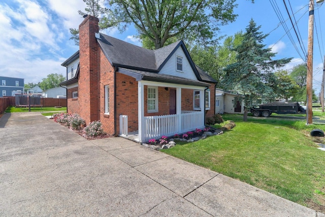 120 W Williams St, Chandler, IN 47610 - view of front of house with covered porch, brick siding, a chimney, and roof with shingles