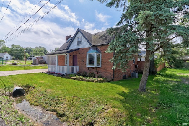 120 W Williams St, Chandler, IN 47610 - view of front facade featuring brick siding, a chimney, cooling unit, and a shingled roof