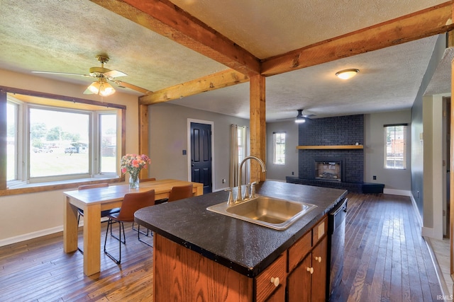 120 W Williams St, Chandler, IN 47610 - kitchen with a ceiling fan, a sink, baseboards, dark wood-style flooring, and a textured ceiling