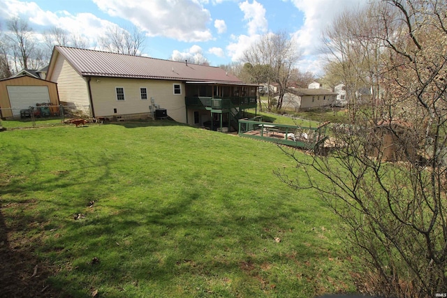 230 N Beechwood Dr, Ellettsville, IN 47429 - back of house featuring a sunroom, metal roof, central AC, an outbuilding, and a detached garage
