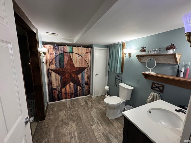 6008 N 600 E, Rochester, IN 46975 - full bathroom featuring wood finished floors, toilet, and vanity