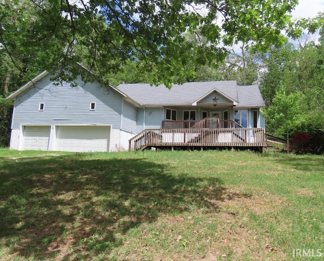 view of front of property with a front lawn, a wooden deck, and an attached garage