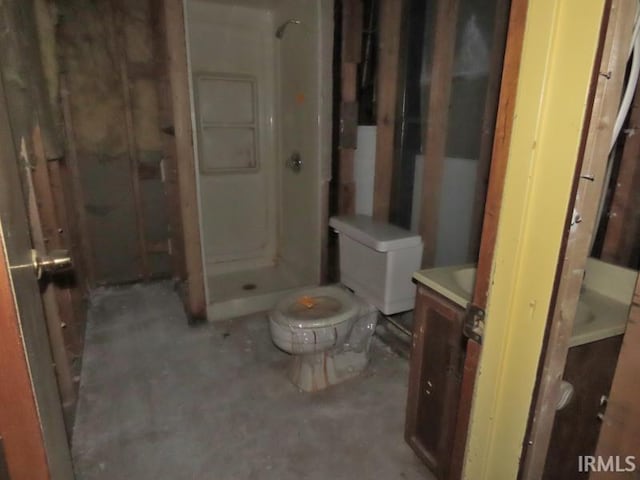 bathroom featuring unfinished concrete flooring, toilet, a shower stall, and vanity