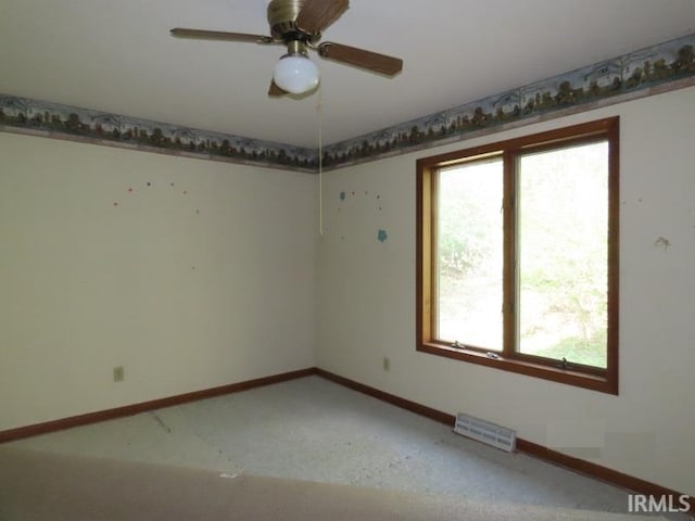 empty room featuring baseboards and ceiling fan