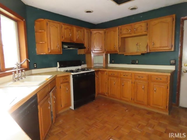 kitchen featuring gas range oven, open shelves, dishwasher, a sink, and under cabinet range hood
