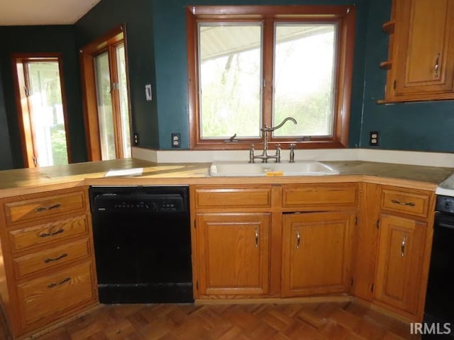 kitchen with dishwasher, a sink, and brown cabinets