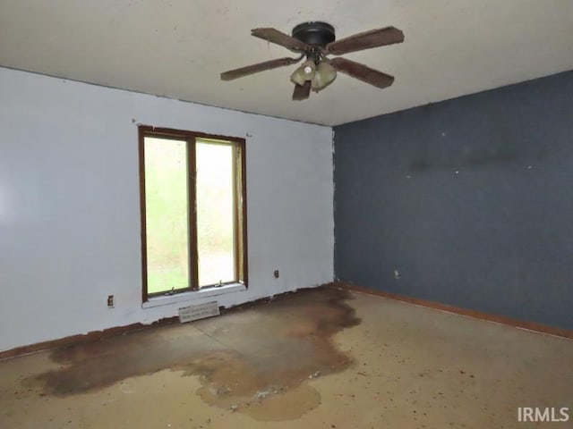 unfurnished room featuring a ceiling fan and baseboards