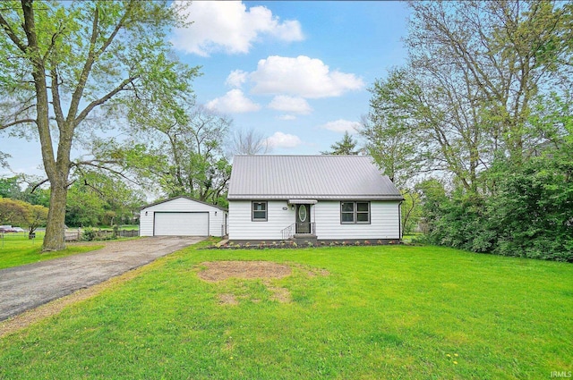 3560 Sandpoint Rd, Fort Wayne, IN 46809 - view of front of house with an outdoor structure, a front yard, a detached garage, and metal roof