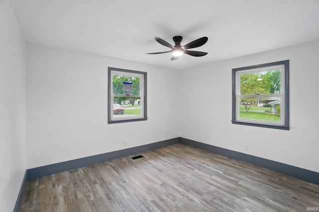 3560 Sandpoint Rd, Fort Wayne, IN 46809 - unfurnished room featuring healthy amount of natural light, baseboards, and wood finished floors