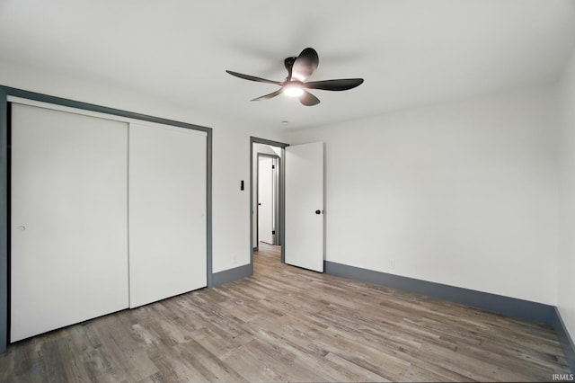 3560 Sandpoint Rd, Fort Wayne, IN 46809 - unfurnished bedroom with wood finished floors, a closet, baseboards, and a ceiling fan
