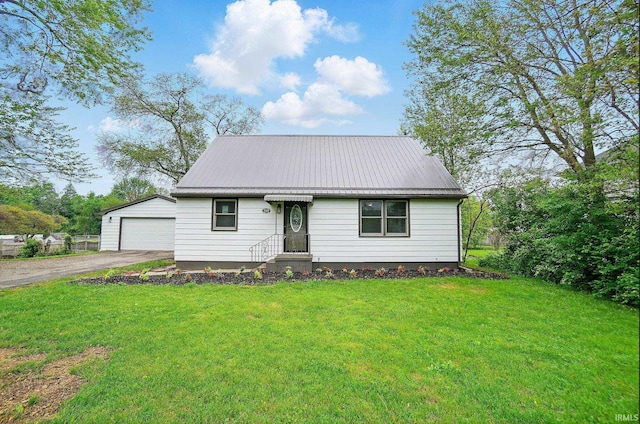 3560 Sandpoint Rd, Fort Wayne, IN 46809 - view of front of property featuring an outbuilding, metal roof, a front lawn, a detached garage, and driveway